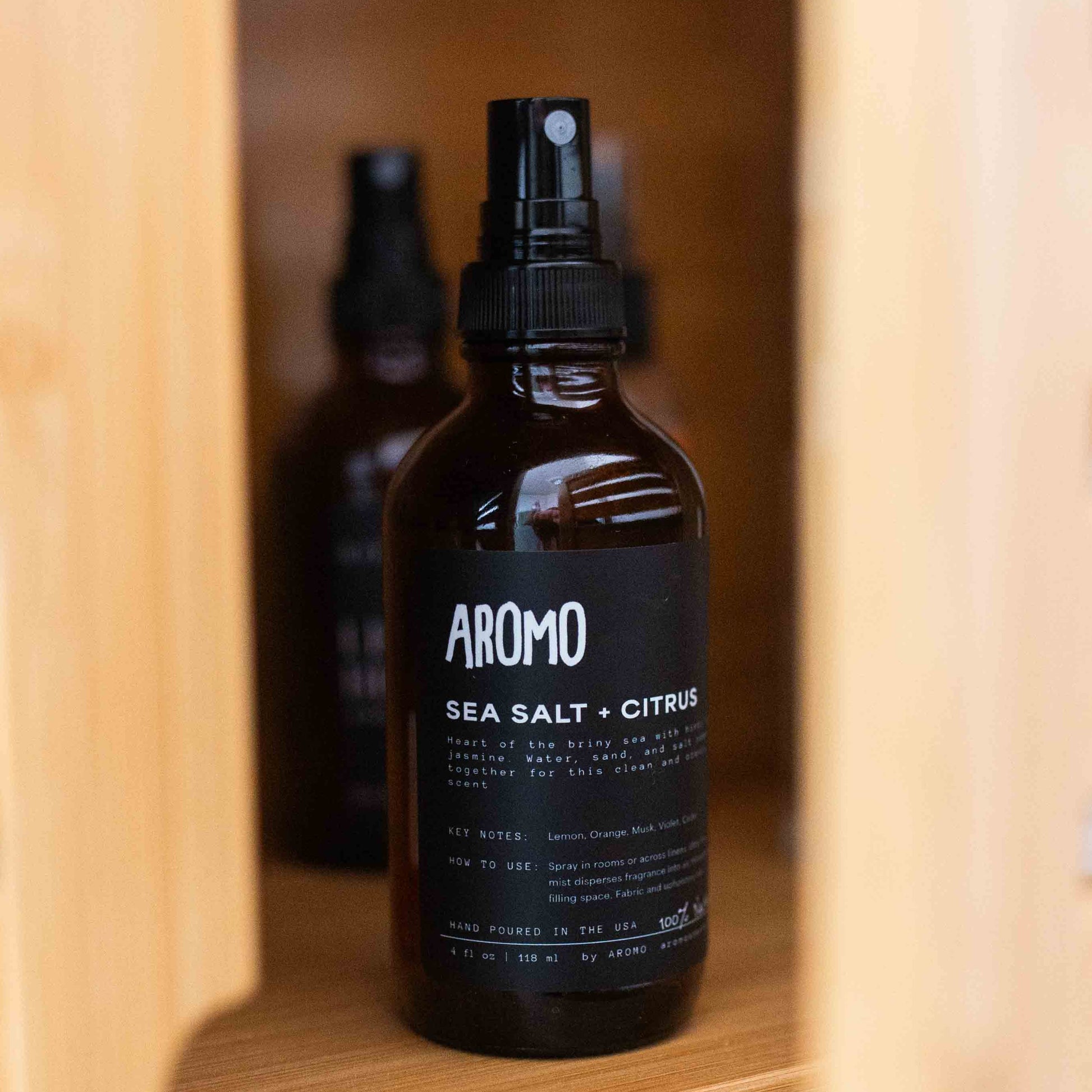 full sized aromo sea salt citrus room and linen spray inside a cabinet