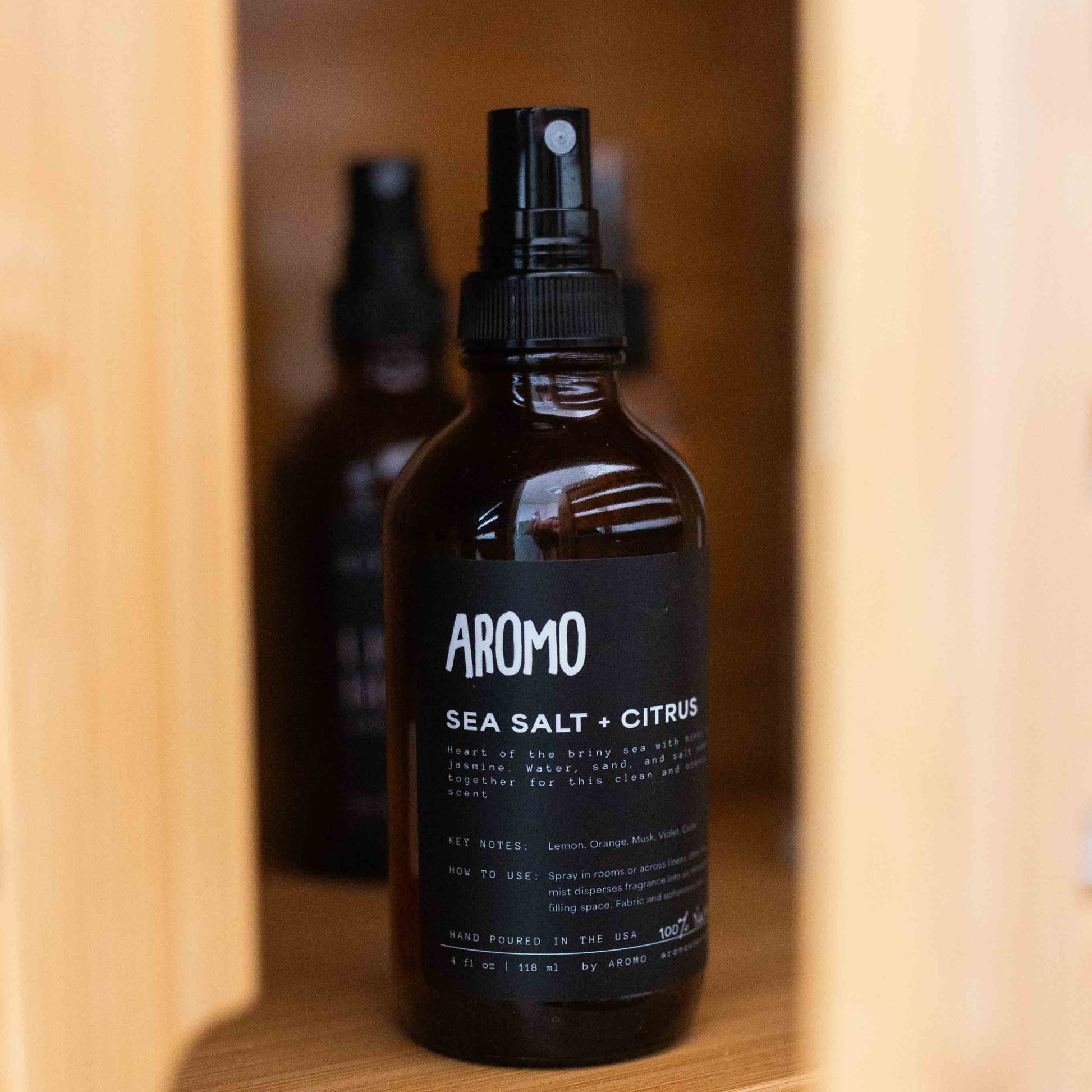 full sized aromo sea salt citrus room and linen spray inside a cabinet